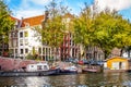 Oudeschans Canal with its historic canal houses and house boats, near the Montelbaans Tower in the center of Amsterdam Royalty Free Stock Photo