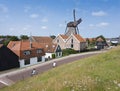 village of oudeschild with windmill on dutch island of texel seen from dike Royalty Free Stock Photo