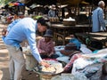 Man buying palmyra palm fruit at a street market in Oudong