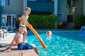 Oudoor summer activity. Concept of fun, health and vacation. Brothers boys eight and five years old with noodle sits