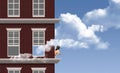 ouds roll in and hover around a woman on the ledge of an apartment building who is watching Royalty Free Stock Photo