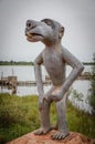 Ouidah, Benin - March 06, 2014: Contemporary arit in form of standing dog sculpture in front of lake