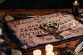 Ouija Board with candles. Seance on wooden table. The mystical atmosphere of the call of spirits. Black magic