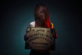 OUIJA Board for divination. Girl holding a OUIJA Board. Woman with long red hair Halloween. Mystic divination conversation