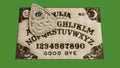 Ouija table isolated on green background
