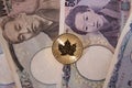1 ounce gold coin on a selection of Japanese yen banknotes