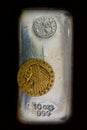 10 Ounce Silver Bullion Bar and Early Gold Coin Royalty Free Stock Photo