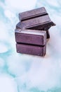 Ounces of chocolate stacked on a blue marble Royalty Free Stock Photo