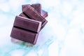 Ounces of chocolate stacked on a blue marble Royalty Free Stock Photo