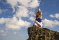 Oung attractive and concentrated woman practicing yoga meditation exercise smiling happy and relaxed at beautiful beach rock cliff