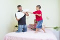 Oung Caucasian Family Having a Playful Funny Pillow Fight Royalty Free Stock Photo