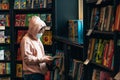 Oung girl in face mask in book shop