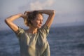 Oung happy beautiful and glamorous blond woman posing as at the beach wearing stylish dress smiling cheerful feeling fresh and fre Royalty Free Stock Photo