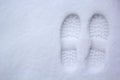 Human`s foot print on a first snow, track, print with arrow