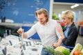 Ouple having fun while choosing fish in the supermarket. Royalty Free Stock Photo