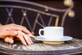 Ouple holding hands, a cup of hot coffee. Couple enjoying coffe. Female and man hands holding cup of coffee. Couple in Royalty Free Stock Photo