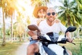 ÃÂ¡ouple travelers riding motorbike scooter under palm trees. Traveling, vacation and transportation concept image