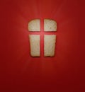 Our daily bread, a metaphor and sign. Cross, Christian values, Christian religion concept. Bread in the form of a cross on a red b