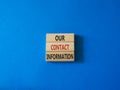 Our contact information symbol. Concept word Our contact information on wooden blocks. Beautiful blue background. Business and Our Royalty Free Stock Photo