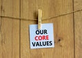 Our core values symbol. White paper with words `Our core values`, clip on wooden clothespin. Beautiful wooden background. Busine Royalty Free Stock Photo