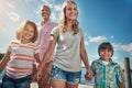 Our family is just the perfect mixture of love. a young family on a pier while out by the lake.