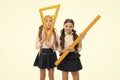 Our favorite lesson. Little girls preparing for geometry lesson. Cute schoolgirls holding triangular and ruler for