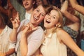 This is our favourite band. Young people dancing in the audience at a musical concert.