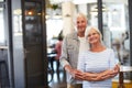 Our favourite place to visit. Portrait of a happy senior couple standing together in a coffee shop. Royalty Free Stock Photo