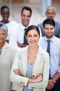 Our figures will speak for themselves. Portrait of a smiling businesswoman surrounded by a group of her colleagues.