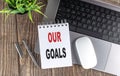 OUR GOALS text on notebook with laptop, mouse and pen Royalty Free Stock Photo