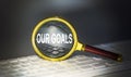 OUR GOALS word concept on a magnifier on the keyboard Royalty Free Stock Photo