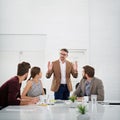 Our growth is exponential. a businessman giving a presentation to colleagues sitting at a table in a modern office. Royalty Free Stock Photo