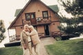 Happy smiling mature twosome hugging near house Royalty Free Stock Photo