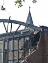 After the fire at a local church auditorium, smoking ruins and rubble, Catholic cross