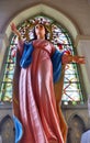 Our lady sculpture and colourful stainglass window in Rosary Kalawar Church Bangkok Royalty Free Stock Photo