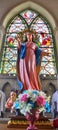 Our lady sculpture and colourful stainglass window in Rosary Kalawar Church Bangkok Royalty Free Stock Photo