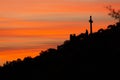 Vibrant Sunrise silhouetting  Mountainside statues of the Virgin Mary  and Large Cross Royalty Free Stock Photo