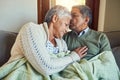 Our love for each other has never changed. an affectionate senior couple relaxing on a sofa together at home. Royalty Free Stock Photo