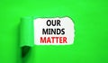 Our minds matter ourmindsmatter symbol. Concept words Our minds matter on beautiful white paper. Beautiful green background. Our Royalty Free Stock Photo