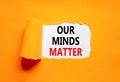 Our minds matter ourmindsmatter symbol. Concept words Our minds matter on beautiful white paper. Beautiful orange background. Our Royalty Free Stock Photo
