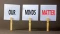 Our minds matter ourmindsmatter symbol. Concept words Our minds matter on beautiful white paper on clothespin. Beautiful grey Royalty Free Stock Photo