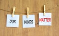 Our minds matter ourmindsmatter symbol. Concept words Our minds matter on beautiful white paper on clothespin. Beautiful wooden Royalty Free Stock Photo