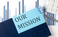 OUR MISSION on sticky note on notebook on the chart background Royalty Free Stock Photo