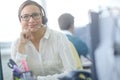 Our operators are always available to assist. an attractive young customer service representative working at her desk in Royalty Free Stock Photo