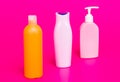 Our packaging solutions. Toiletry bottles pink background. Refillable bottles in row