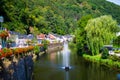 Our river crossing the old town of Vianden, Luxembourg, with typical houses, trees and the mountain at the background Royalty Free Stock Photo