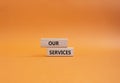 Our services symbol. Concept words Our services on wooden blocks. Beautiful orange background. Business and Our services concept.