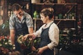 Our small business is flourishing. two young florists trimming flowers and working together inside their plant nursery. Royalty Free Stock Photo