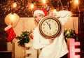 Our traditions. girl in red santa claus hat. Midnight. xmas mood. Woman wi clock. winter holidays. Its time for Royalty Free Stock Photo