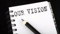 OUR VISION written text in a small notebook on a black background Royalty Free Stock Photo